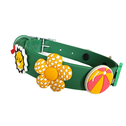 Green dog collar with colorful flower and ball decorations on a white background